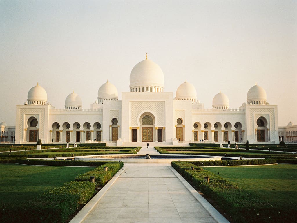 Grand white palace and formal gardens in Abu Dhabi